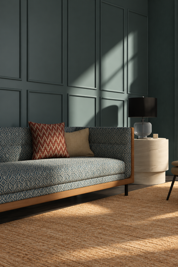 RM Coco luxury designer fabrics featuring textured gray drapery and decorative pillows in an elegant contemporary living room.