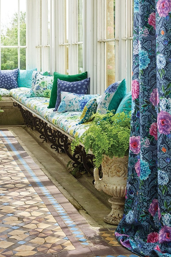 Matthew Williamson for Osborne & Little floral drapery fabric with vibrant pink and blue flowers in an elegant conservatory