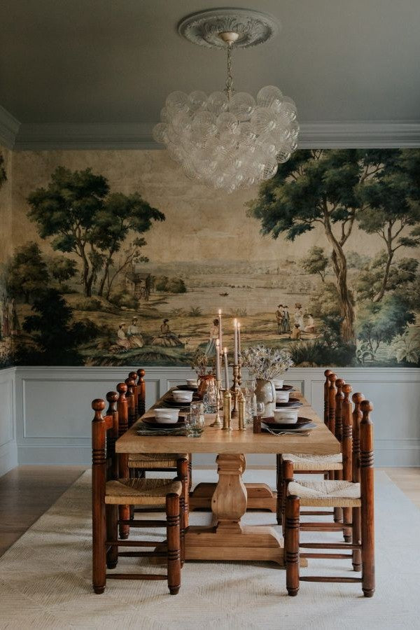 Dining room with patterned designer wallpaper and a table set for holiday guests