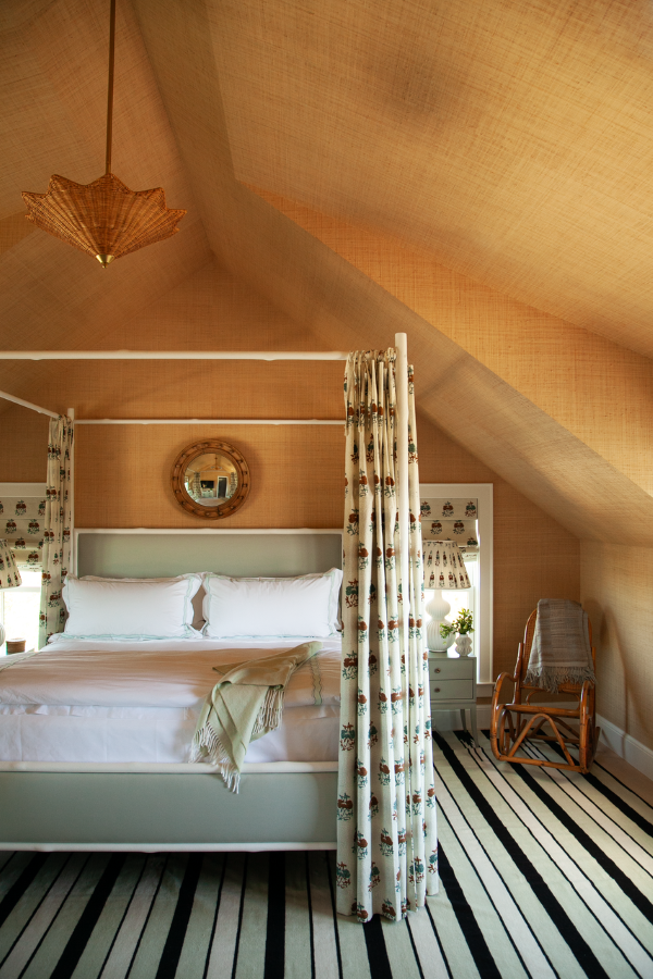 Phillip Jeffries Island Raffia wallcovering in Sea Wall Beige on a bedroom with a canopy bed