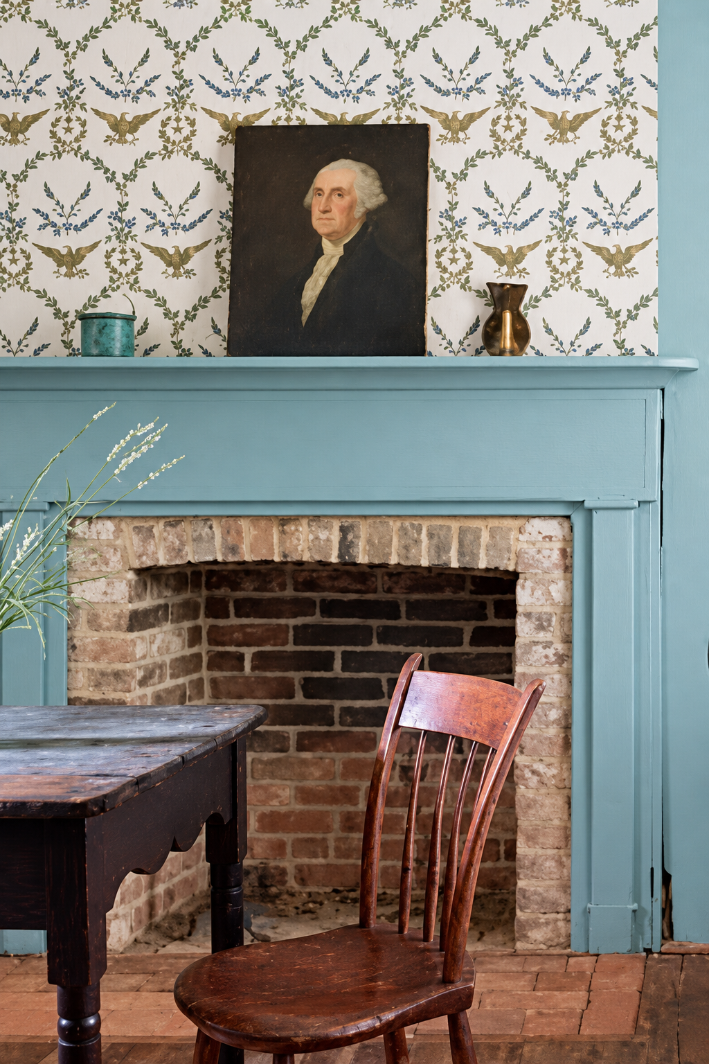 Schumacher Yankee Doodle Dandy collection eagle-motif wallpaper above a blue mantel, styled with a George Washington portrait.